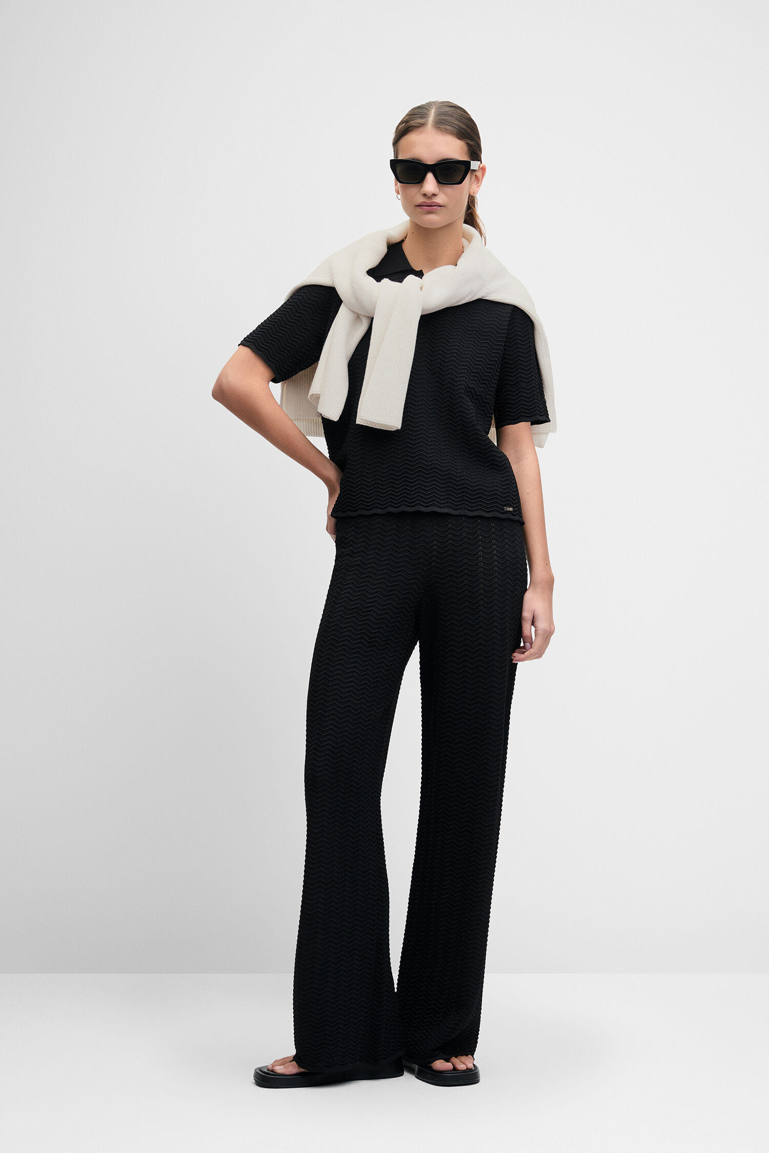 black outfit, jumpsuit, palazzo pants, textured fabric, sunglasses